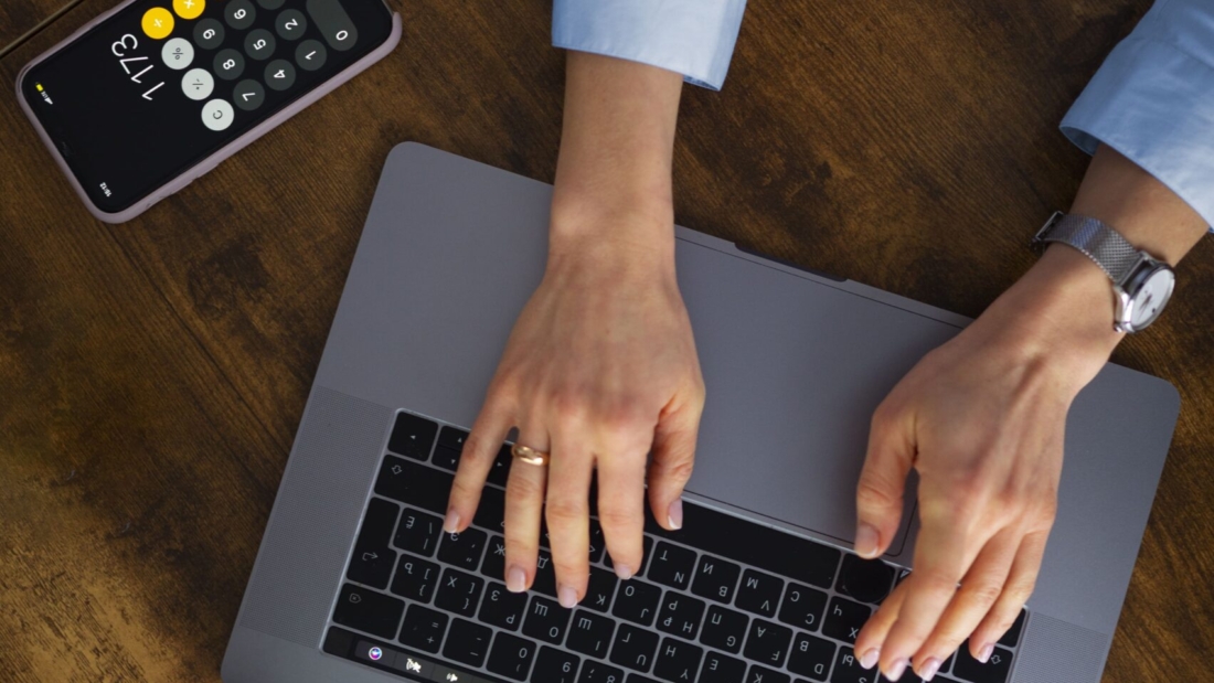 view-woman-typing-laptop-min